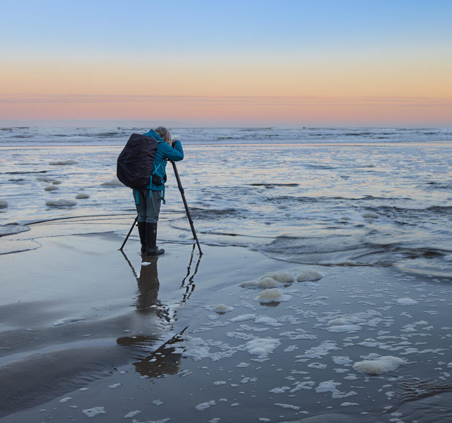 Getting wet at the coast to get the photo Photographer in action on the Oregon coast